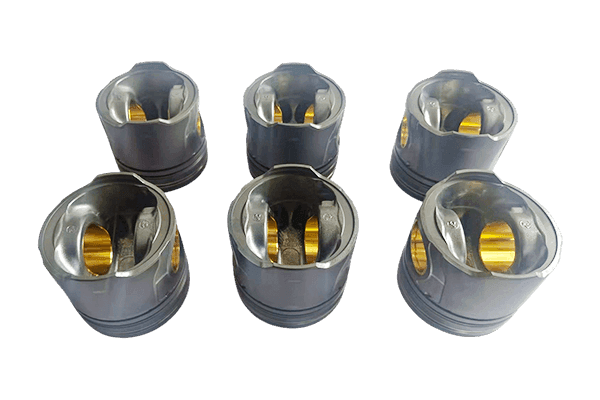 Six engine pistons with visible crown recesses